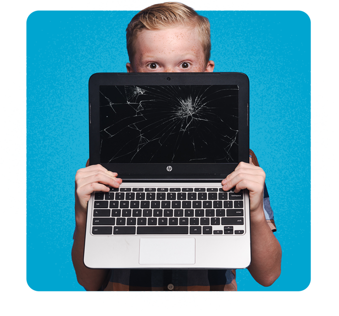 A boy with a broken Chromebook screen